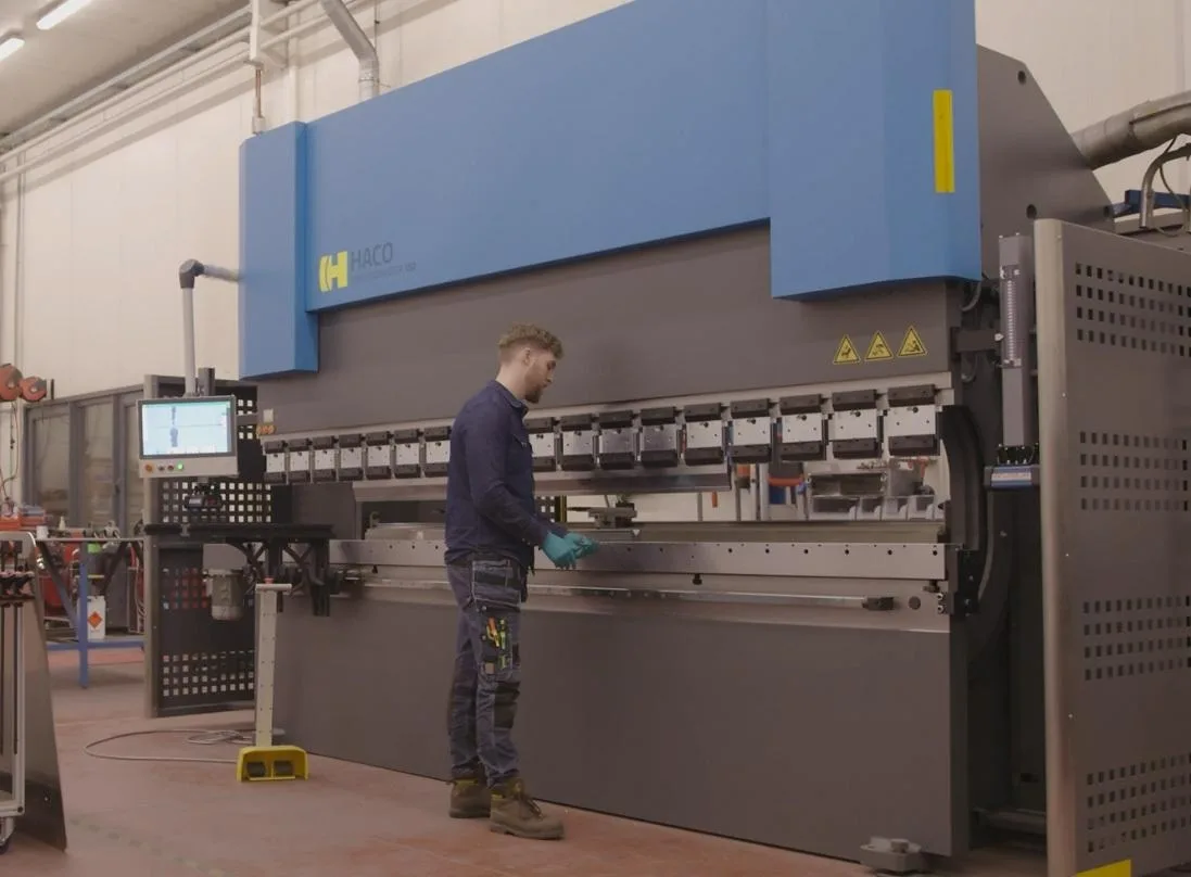 An operator at work on a Haco press brake